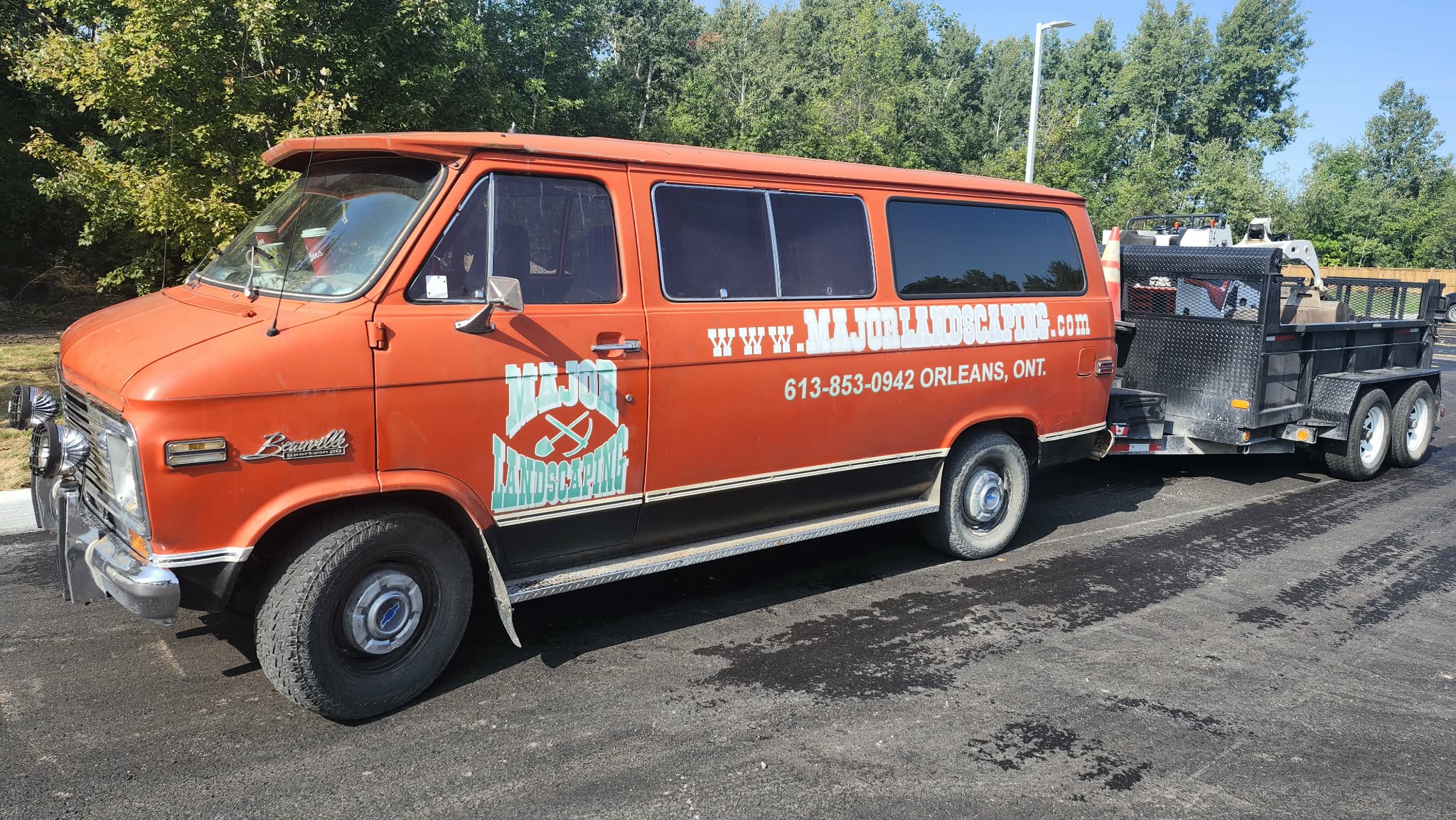Major Landscaping orange van parked on site